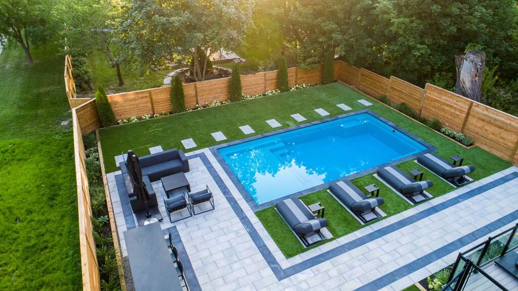 High-end backyard design around fiberglass pools in Toronto