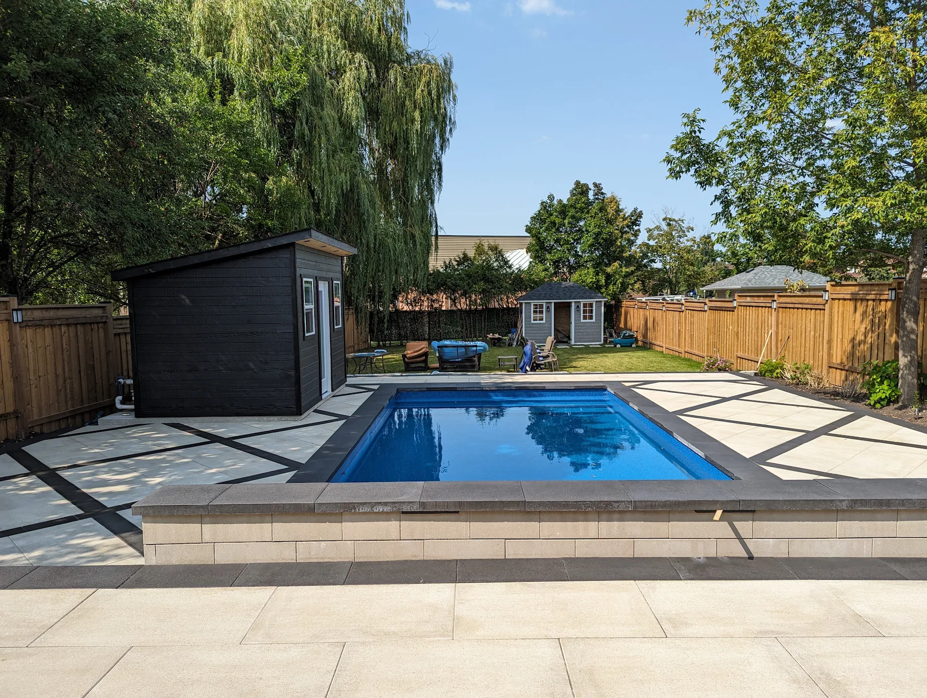 Inground pool with modern black cabana built by Land-Con Pools in Toronto