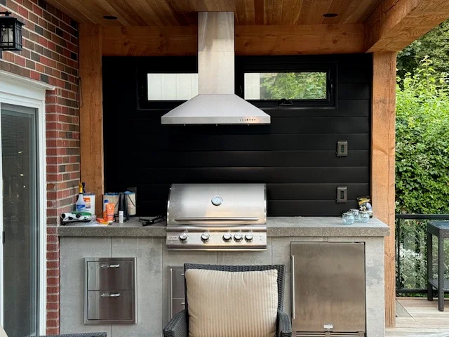Covered outdoor kitchen with built-in grill installed by Land-Con Pools in Toronto